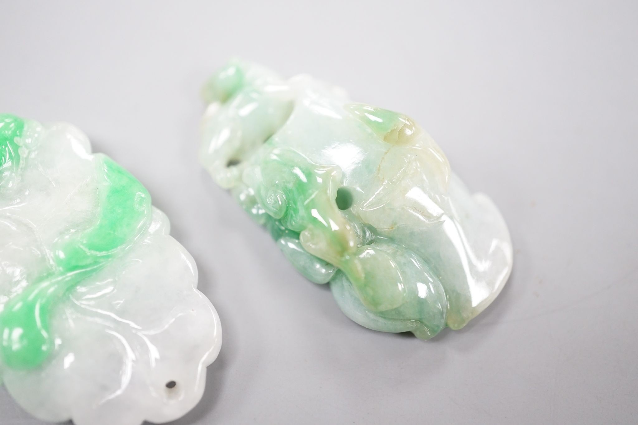 Two carved jade pendants, largest 45mm.